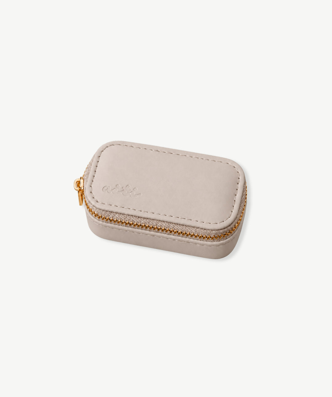 Mini travel jewelry case open with earrings and rings in padded slots
